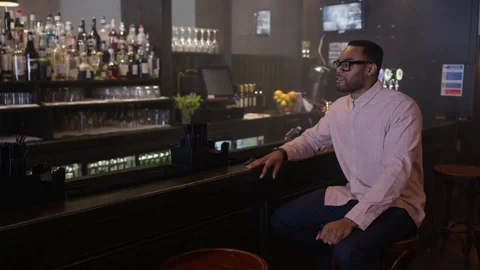 4K Young Couple Chatting &amp; Bartender Serving Drinks In Trendy City Bar Video stock 75611174