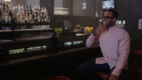 4K Young Couple Chatting &amp; Bartender Serving Drinks In Trendy City Bar Stock Footage 75612585