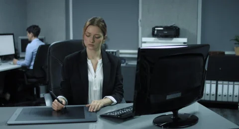 4K: A young designer works on the PC with a drawing tablet. Stock Footage 67432742