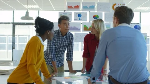 4K Young designers collaborating on a project in creative office Stock Footage 76021697