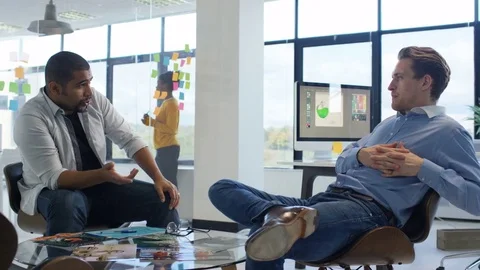 4K Young designers collaborating on a project in creative office Stock Footage 76023683