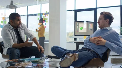 4K Young designers collaborating on a project in creative office Stock Footage 76023734