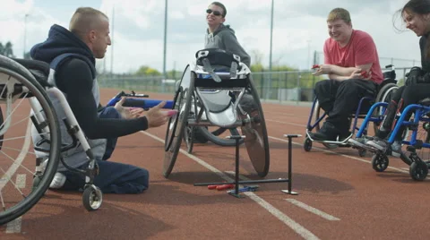 4K Young disabled adults taking advice from experienced athlete in sports sessio Stock Footage 64576693