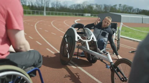 4K Young disabled adults taking advice from experienced athlete in sports sessio Stock Footage 64577060