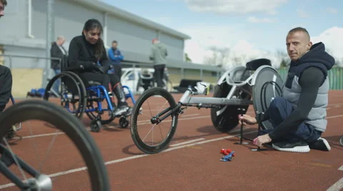 4K Young disabled adults talking to experienced athlete in sports session Stock Footage 64577403