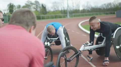 4K Young disabled adults talking to experienced athletes in sports session Stock Footage 64583585