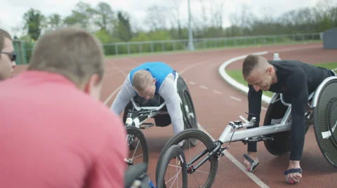4K Young disabled adults talking to experienced athletes in sports session Stock Footage 64583894