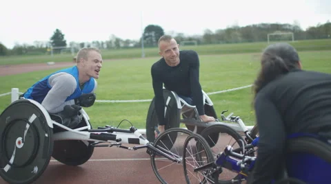 4K Young disabled adults talking to experienced athletes in sports session Stock Footage 64586390