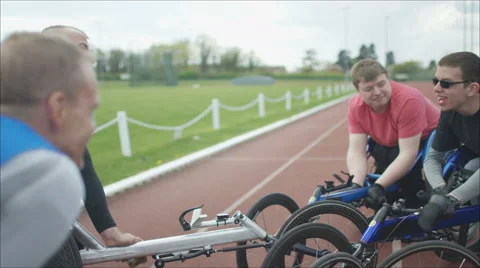4K Young disabled adults talking to experienced athletes in sports session Stock Footage 64586883