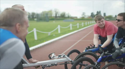 4K Young disabled adults talking to experienced athletes in sports session Stock Footage 64587319
