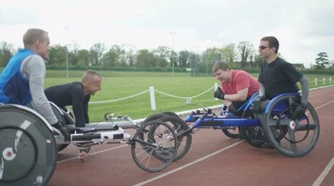 4K Young disabled adults talking to experienced athletes in sports session Stock Footage 64587525