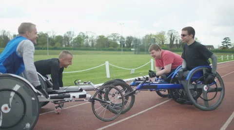 4K Young disabled adults talking to experienced athletes in sports session Stock Footage 64587758