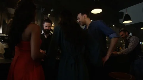 4K Young Diverse Group Socializing &amp; Bartender Serving Drinks In Trendy City Bar Video stock 75639447