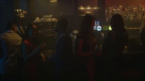 4K Young Diverse Group Socializing &amp; Bar Staff Serving Drinks In Trendy City Bar Stock Footage 75796971