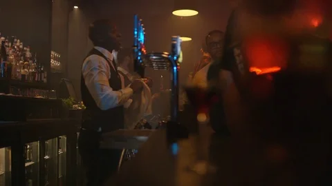 4K Young Diverse Group Socializing &amp; Bar Staff Serving Drinks In Trendy City Bar Stock Footage 75797757
