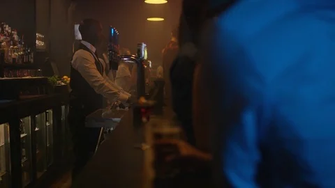 4K Young Diverse Group Socializing &amp; Bar Staff Serving Drinks In Trendy City Bar Stock Footage 75798180