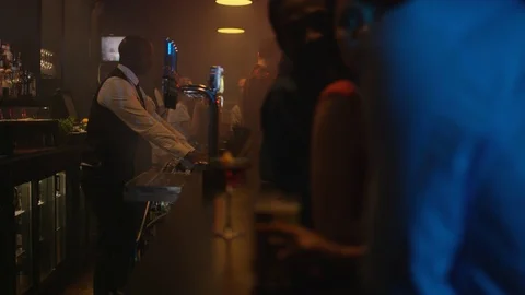 4K Young Diverse Group Socializing &amp; Bar Staff Serving Drinks In Trendy City Bar Stock Footage 75798451