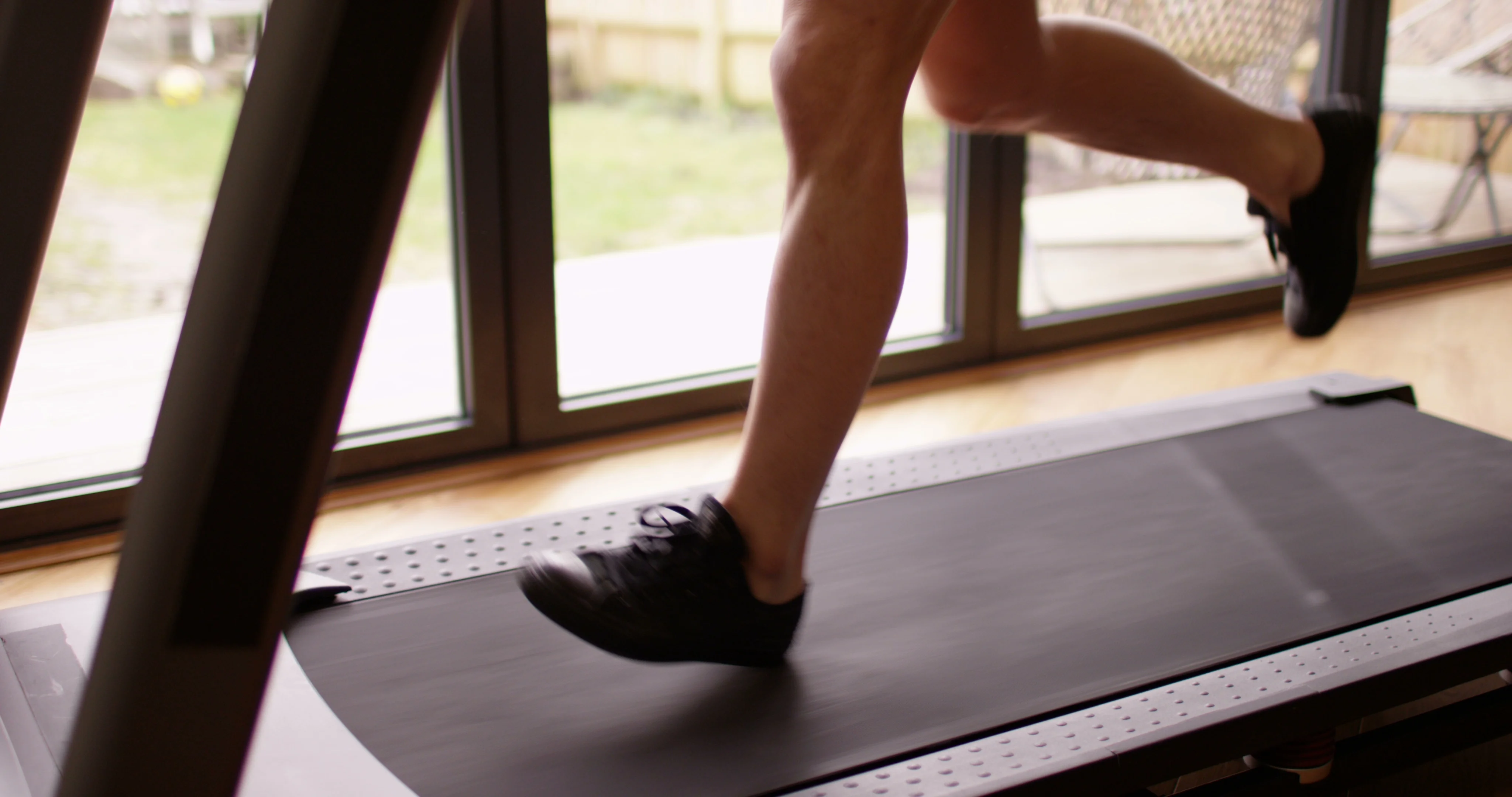 4K Young fit Asian guy running on treadmill in home gym