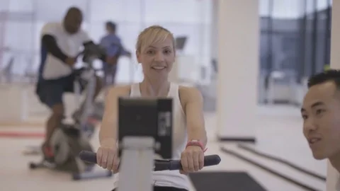 4K Young fit group working out in the gym with fitness instructor supervising Stock Footage 75860146