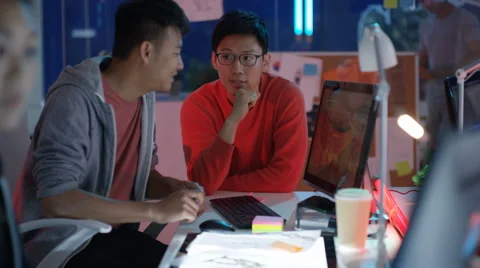 4K Young game designers looking at computer screen &amp; discussing interface design Stock Footage 67563934