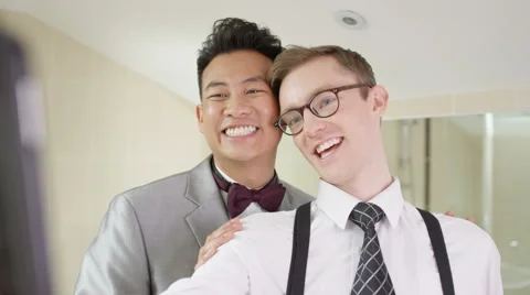 4K Young gay couple on wedding day pose to take a selfie with mobile phone Stock Footage