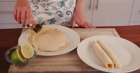 4K Young girl rolling pancakes Stock Footage 64694792