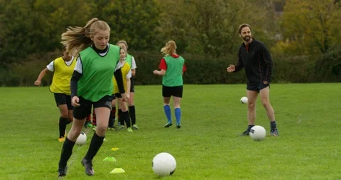 4K Young girls training with the coach at British soccer training academy Stock Footage 86282283
