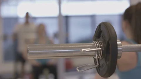 4K Young group working out in the gym, trainer spotting for girl lifting weights Video stock 75861716