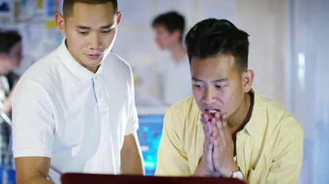 4K Young male computer programmers working together in small office Stock Footage 54471712