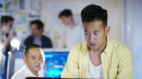 4K Young male computer programmers working together in small office Stock Footage 54472497