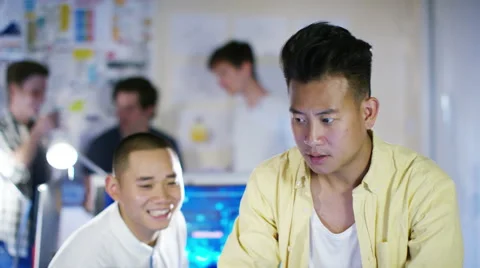 4K Young male computer programmers working together in small office Stock Footage 54472948