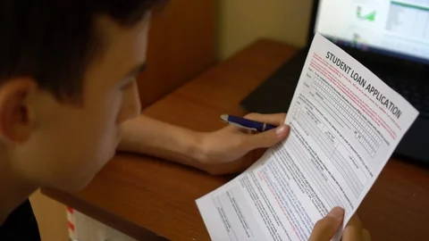 4k. A young man is applying for a student loan Video stock 94788698