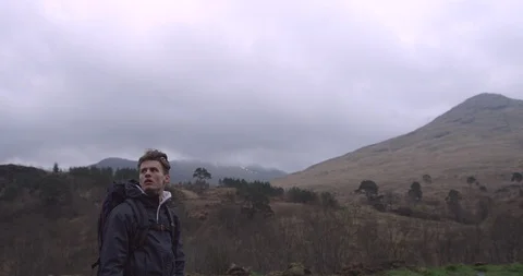 4K Young Man with Backpack in the Scottish Glen Coe Mountain Highlands. Student. Stock Footage 93095760