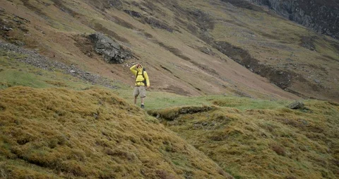 4K A Young Man in The Glen Coe Scottish Mountains. A Hiker in Yellow jacket. Stock Footage 93021886
