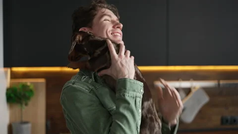 4k Young man is having fun with cute dog and standing in home kitchen spbd. Stock Footage 198823506