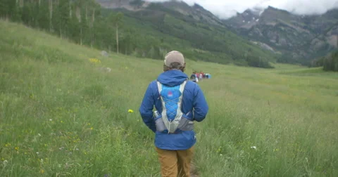 4k Young man hike on trail in Colorado mountain valley Stock Footage 56567063