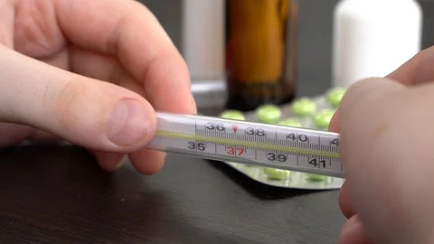 4K. Young man looking at thermometer. Stock Footage 129975199