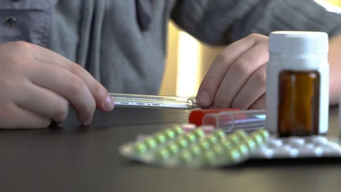 4K. Young man looking at thermometer. Stock Footage 129975228