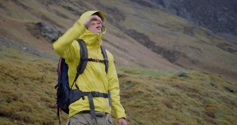 4K A Young Man Lost in The Glen Coe Scottish Mountains.Student in Yellow jacket. Stock Footage 93027512
