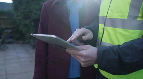 4K Young man outside his home getting planning advice from builder or architect Stock Footage 49622611