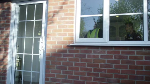 4K Young man outside his home getting planning advice from builder or architect Stock Footage 49623050