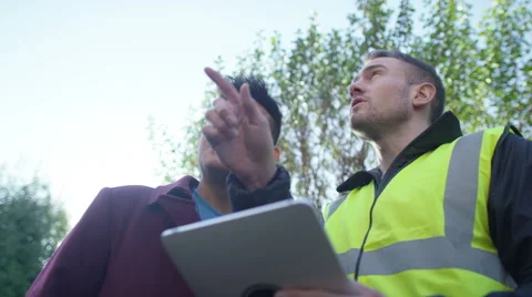 4K Young man outside his home getting planning advice from builder or architect Stock Footage 49641017