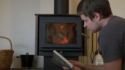 4k Young Man Reading By Fire Zoom Stock Footage 40316116