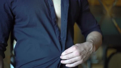4K Young Man Unbuttoning A Blue Shirt Close-Up Stock Footage 232852566