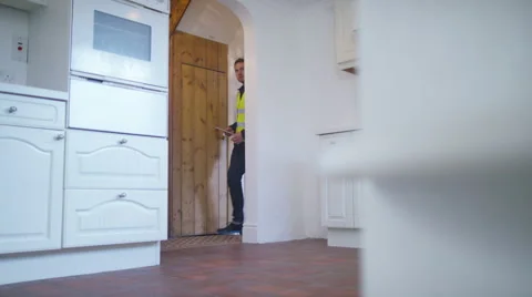 4K Young man viewing new home gets planning advice from builder or architect Stock Footage 49623684