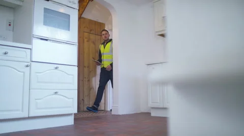 4K Young man viewing new home gets planning advice from builder or architect Stock Footage 49623896