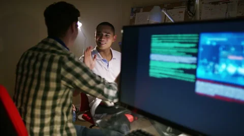 4K Young men working in front of computers with headphones on Stock Footage 54425534