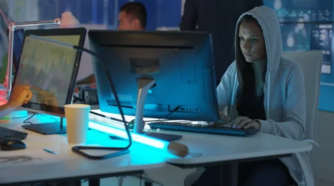 4K Young mixed ethnicity computer game design team working in dark office Video stock 67899162