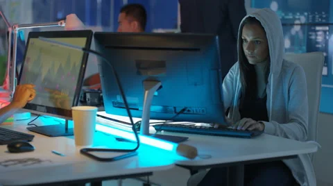 4K Young mixed ethnicity computer game design team working in dark office Video stock 67899195