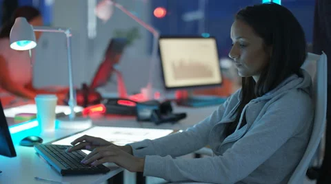 4K Young mixed ethnicity computer game design team working in dark office Video stock 67900120